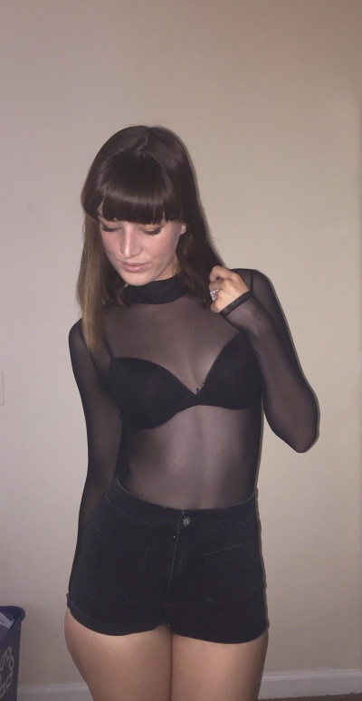 In a black transparent bodysuit